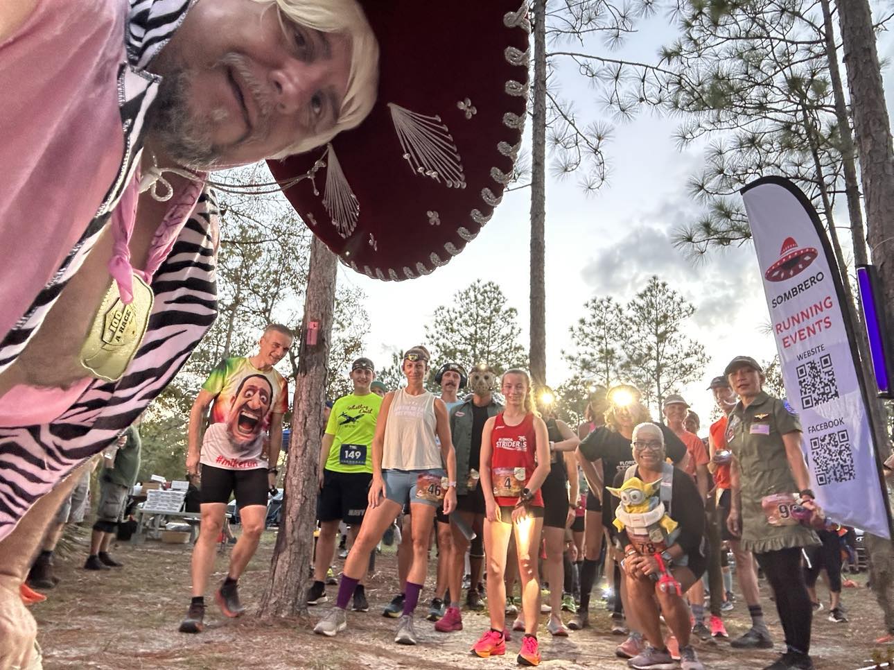 Running event participants posed for picture at run location.