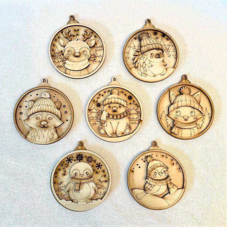 set of seven woodcut ornaments in various christmas designs