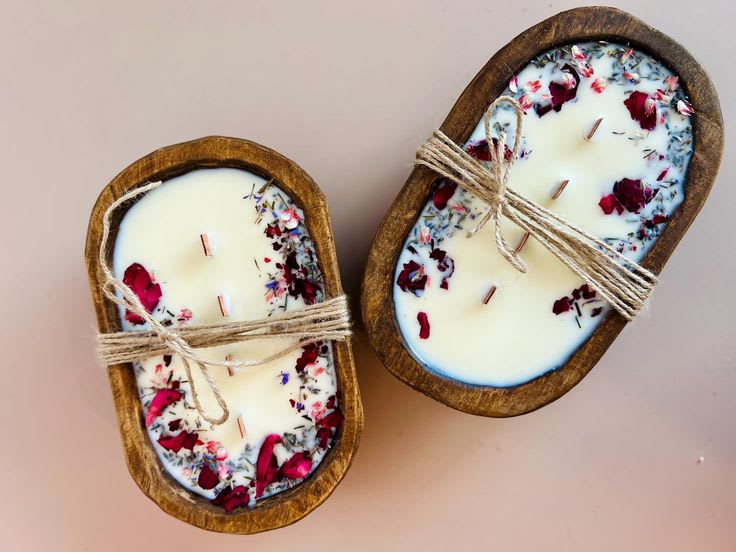 Two handmade candles wrapped in twine.