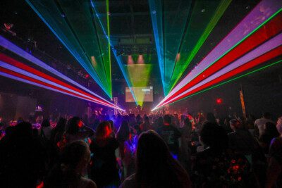 Crowd watching a multi-colored laser show.