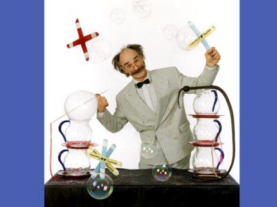 Man posing for picture posed with scientific objects.