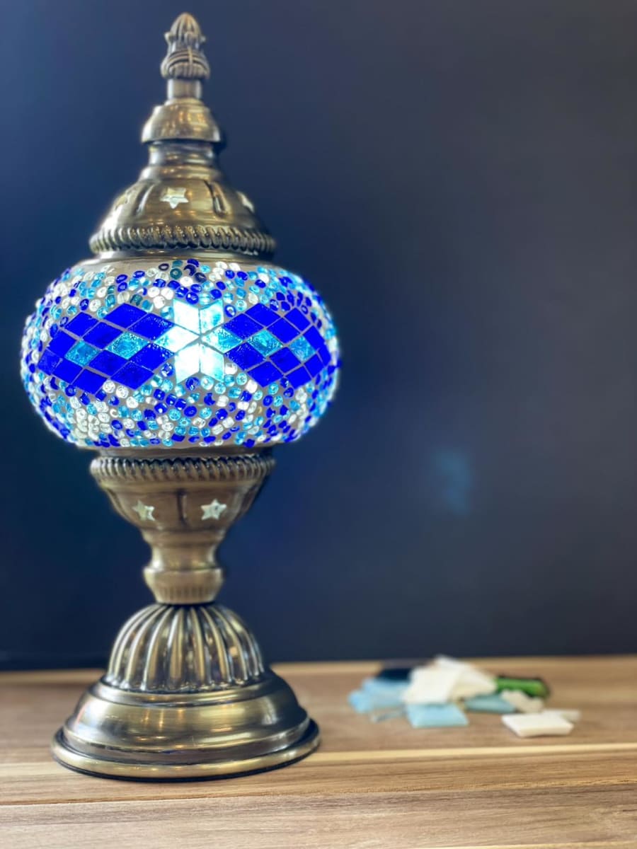 Photo of a mosaic lantern with blue glass.