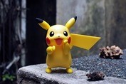 Picture of Pokemon action figure placed on a gray stone.