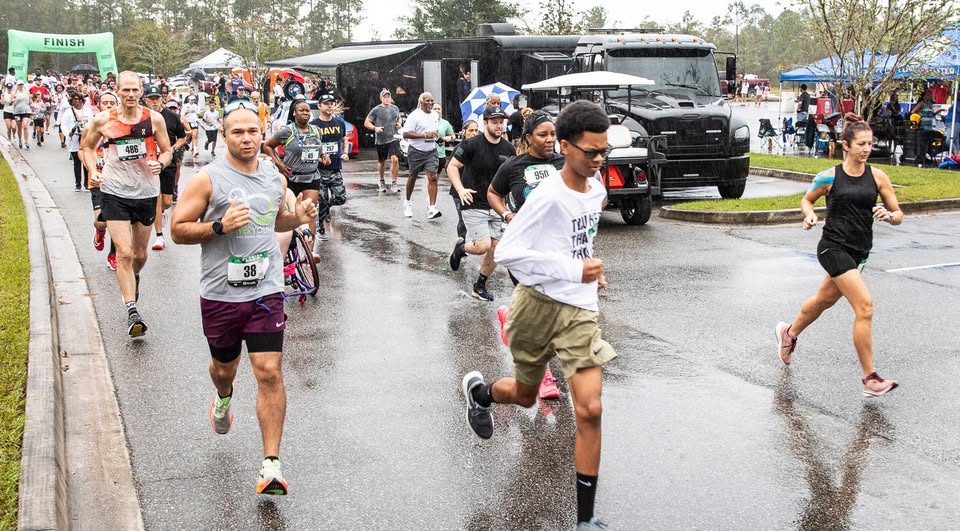 Photo of runners competing in a past race on a paved street.